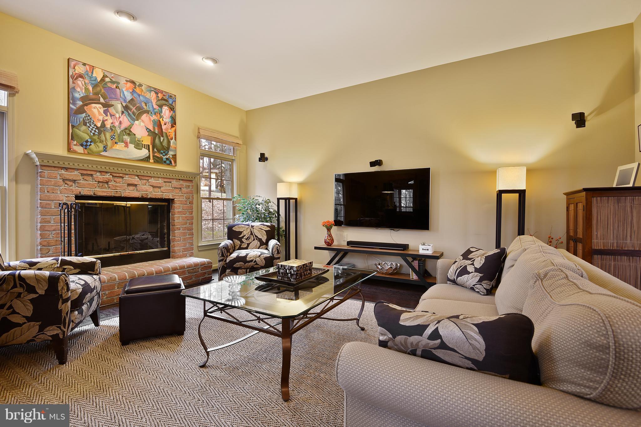 5607 South Bend Road Baltimore, MD 21209 - Photo 13 of 30 a living room with furniture a fireplace and a flat screen tv