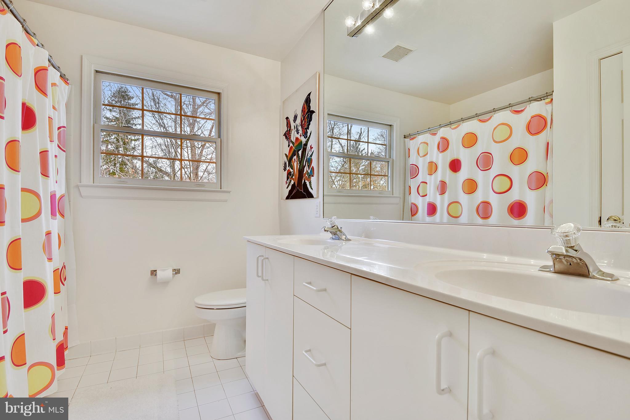 5607 South Bend Road Baltimore, MD 21209 - Photo 19 of 30 a bathroom with a sink a toilet and a window