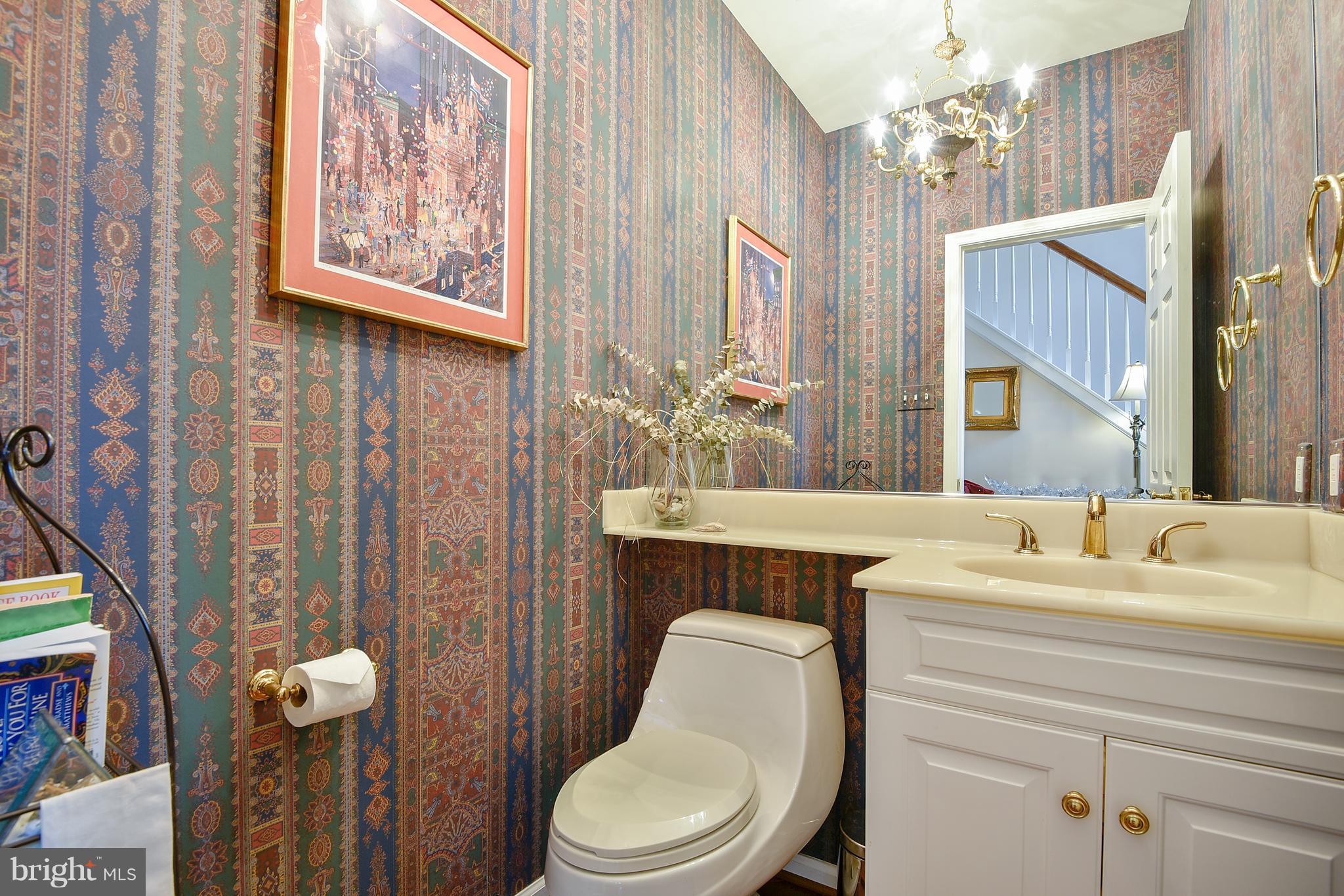 5607 South Bend Road Baltimore, MD 21209 - Photo 4 of 30 a bathroom with a toilet a sink and a mirror