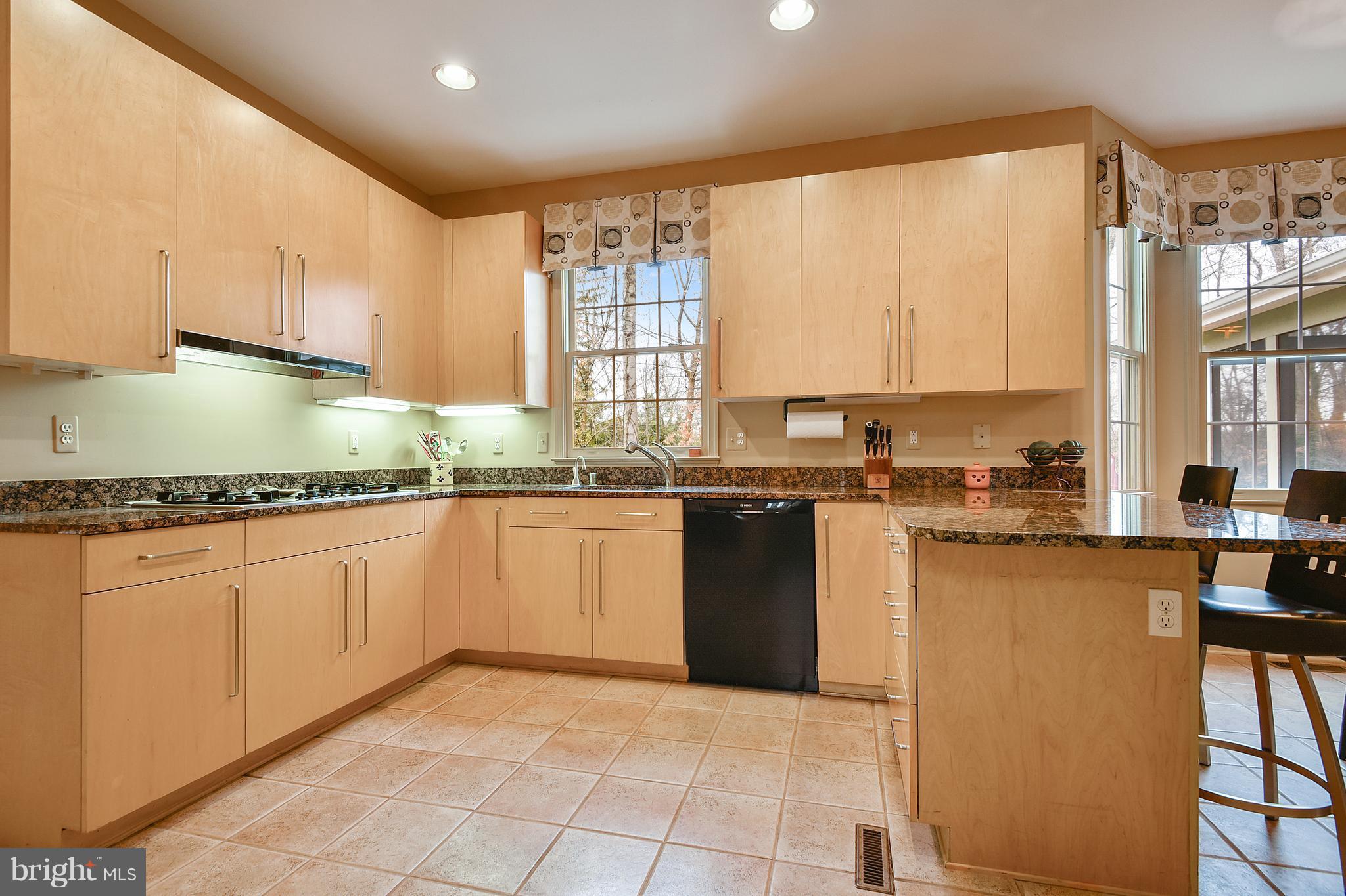 5607 South Bend Road Baltimore, MD 21209 - Photo 6 of 30 a kitchen with granite countertop a sink stainless steel appliances and cabinets