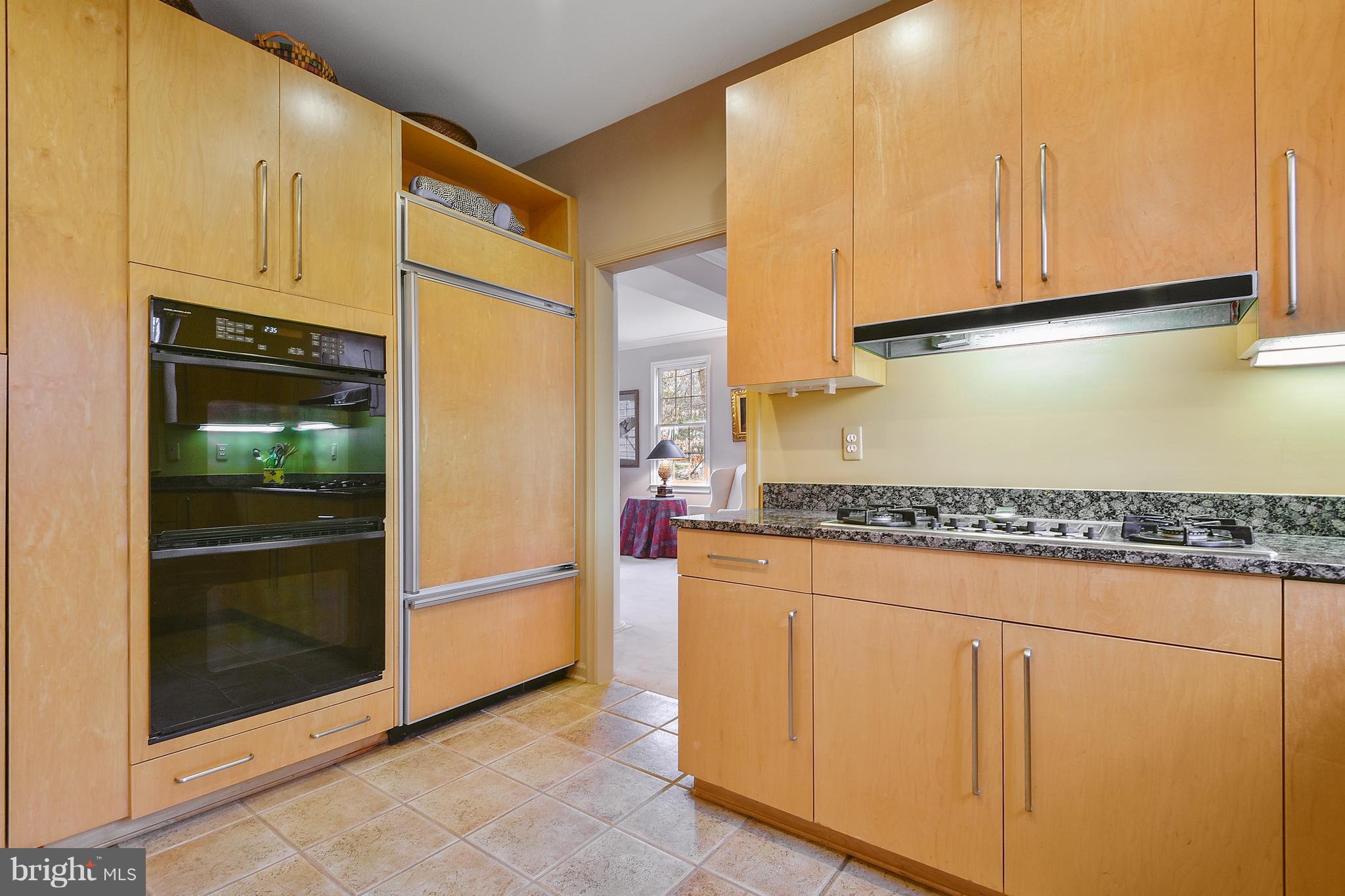 5607 South Bend Road Baltimore, MD 21209 - Photo 7 of 30 a kitchen with a refrigerator a stove and cabinets