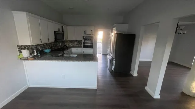 a kitchen with a refrigerator and a sink