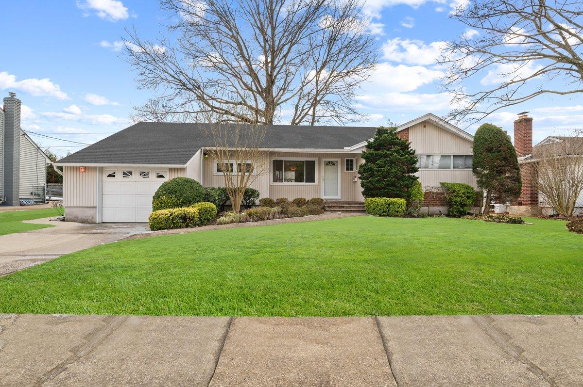 1370 Wilson Road East Meadow, NY 11554 - Photo 1 of 1 Single story home with a garage and a front yard