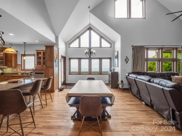 a living room with furniture a fireplace and a large window