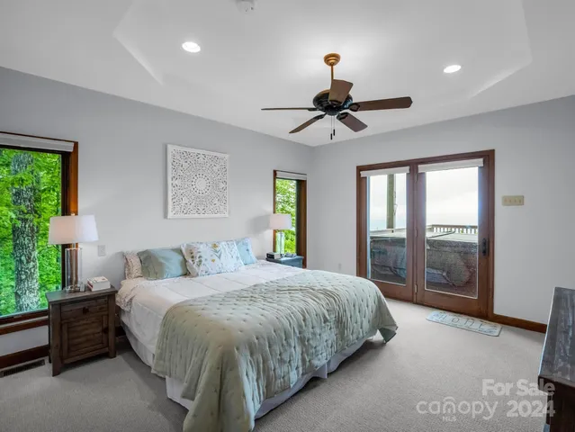 a view of roof deck with table and chairs a barbeque