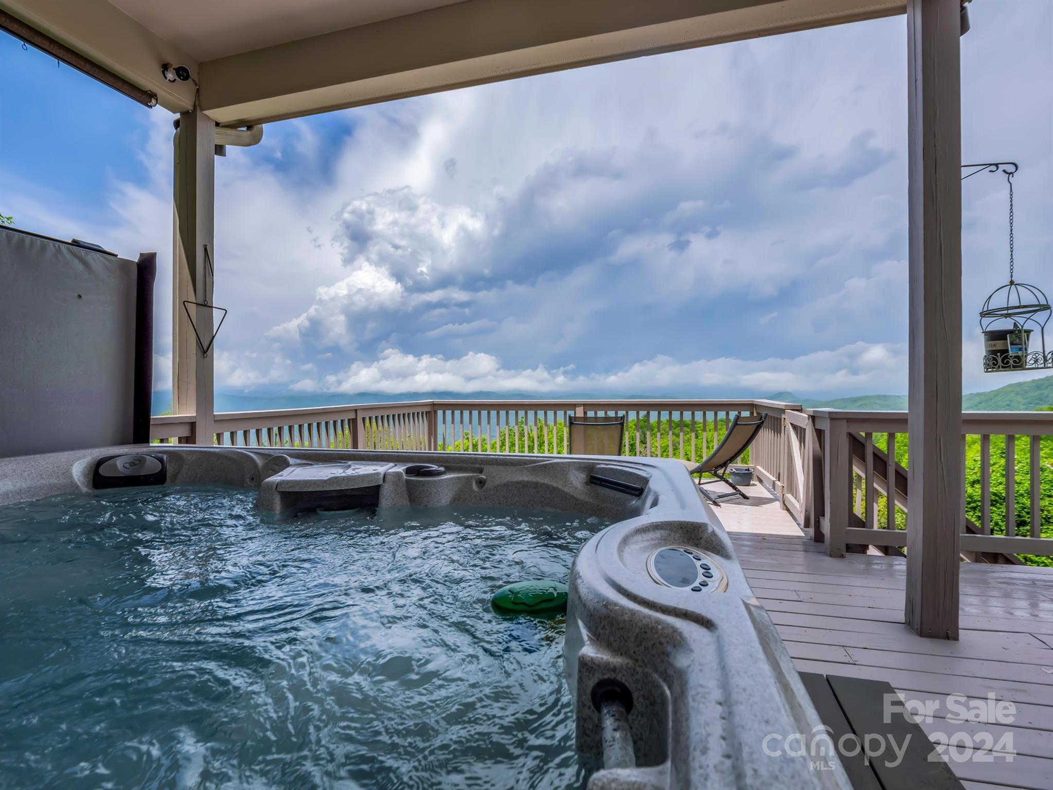 428 Devils Hole Road, Unit 14 Rosman, NC 28772 - Photo 21 of 47 a view of roof deck with table and chairs a barbeque