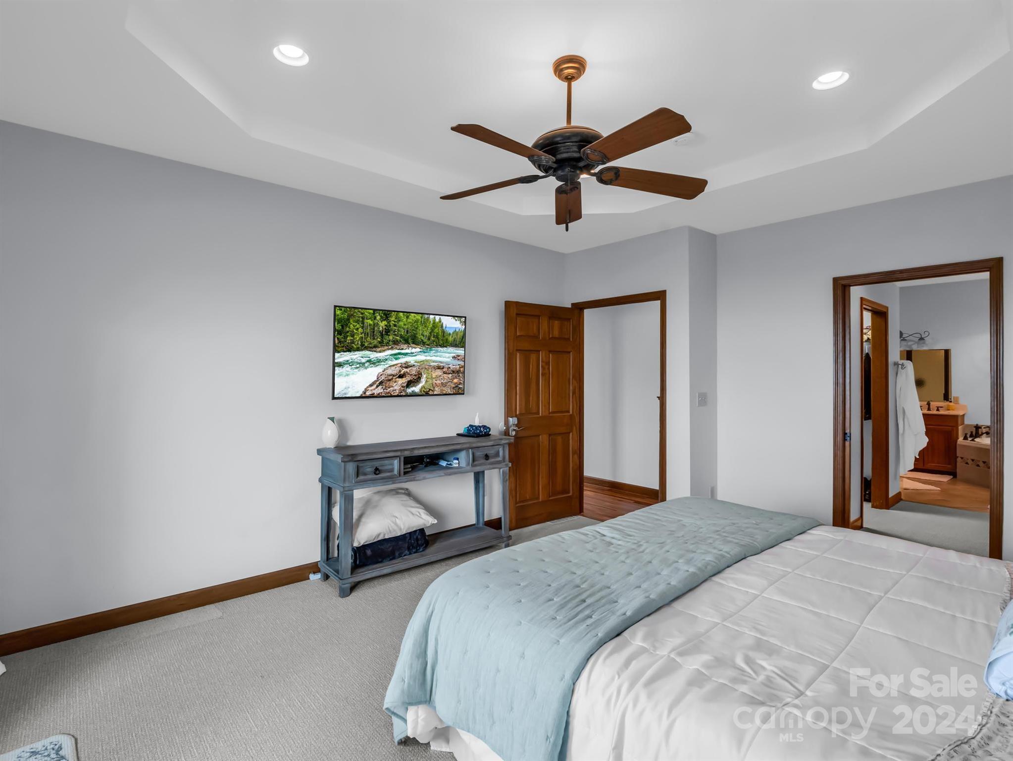 428 Devils Hole Road, Unit 14 Rosman, NC 28772 - Photo 22 of 47 a bedroom with a bed and a chandelier