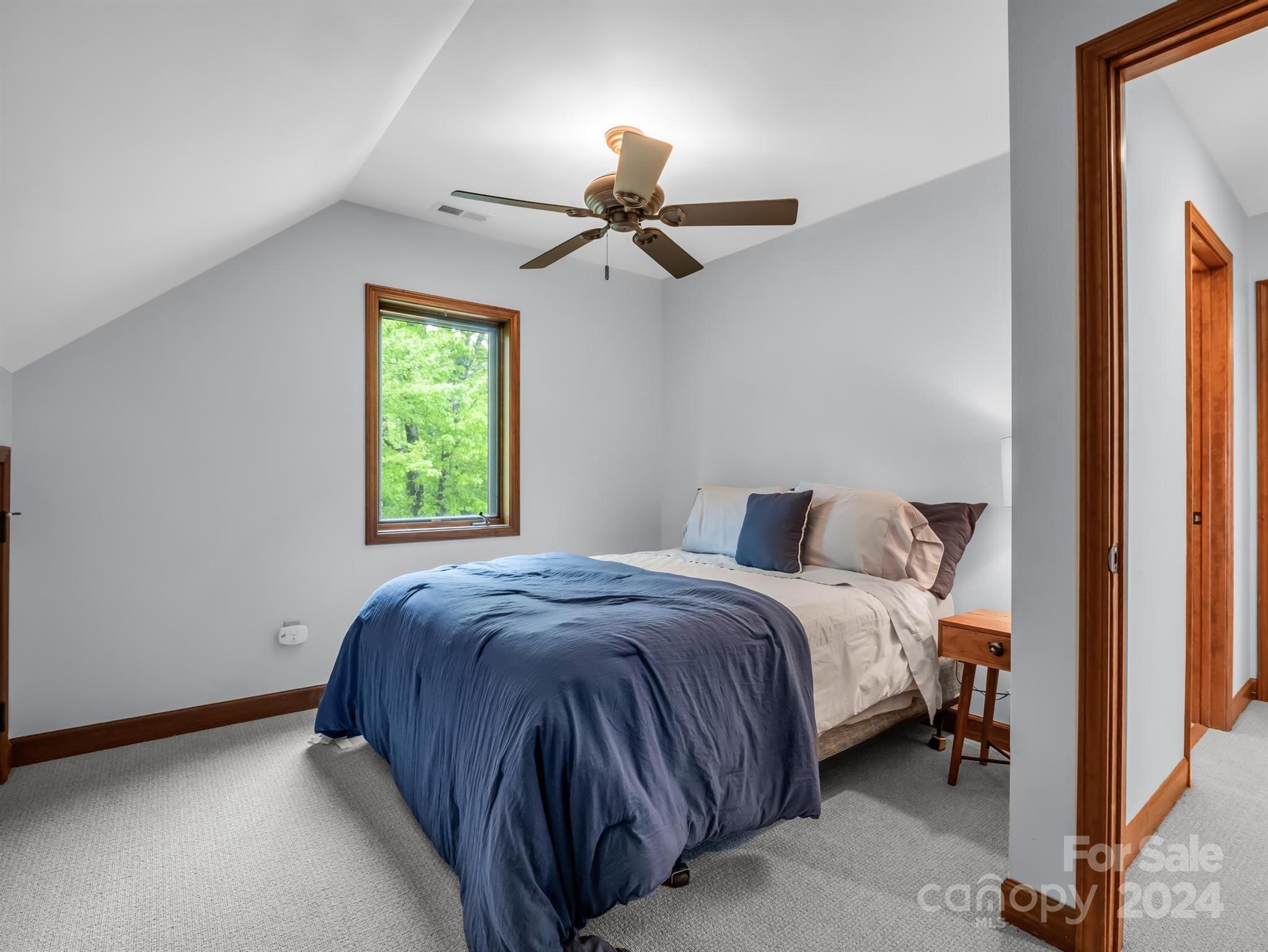 428 Devils Hole Road, Unit 14 Rosman, NC 28772 - Photo 27 of 47 a bedroom with a bed and a window