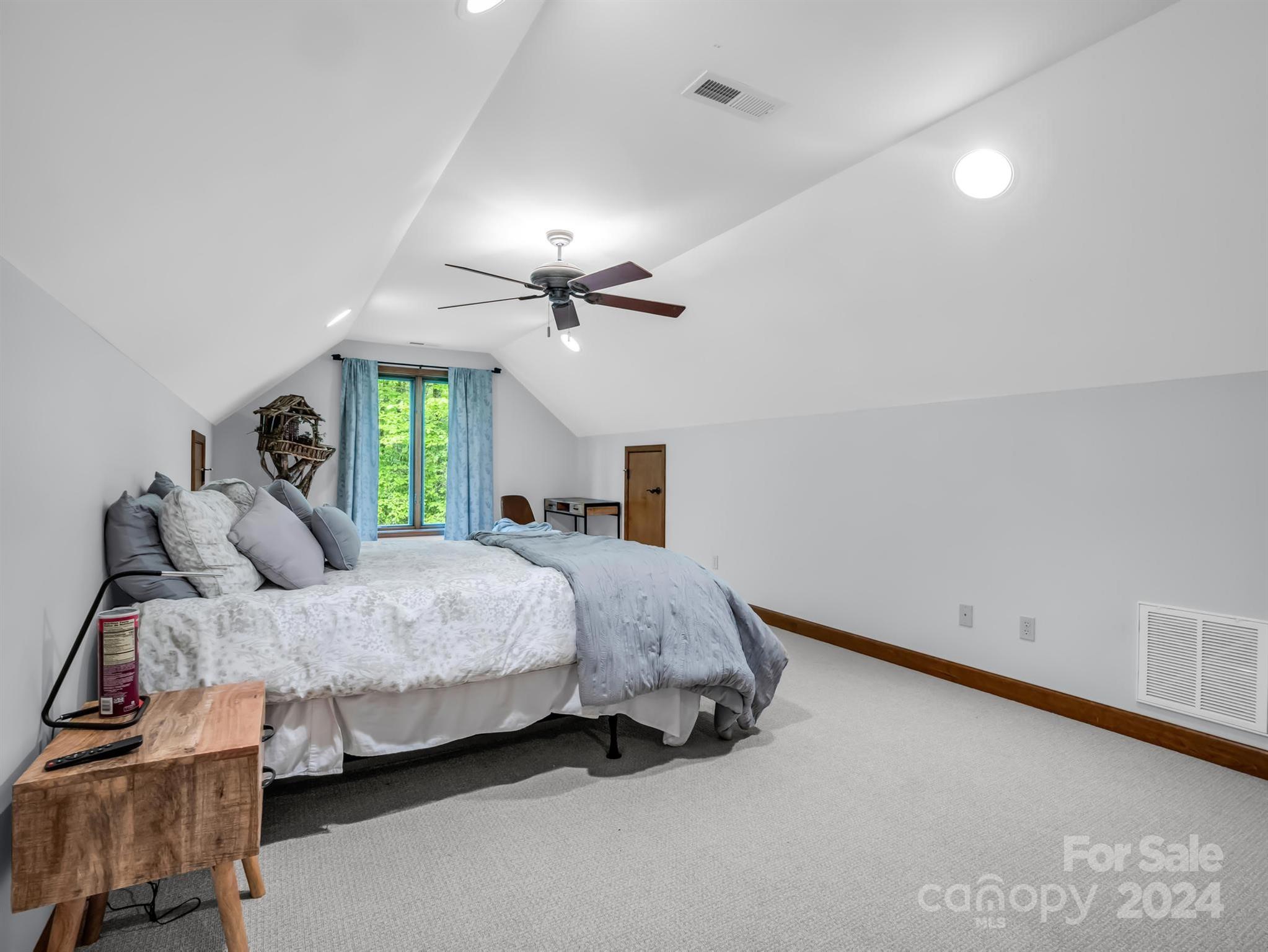 428 Devils Hole Road, Unit 14 Rosman, NC 28772 - Photo 31 of 47 a bedroom with a bed and window