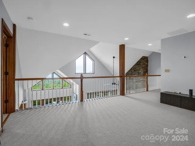 a spacious bedroom with a bed and a chandelier