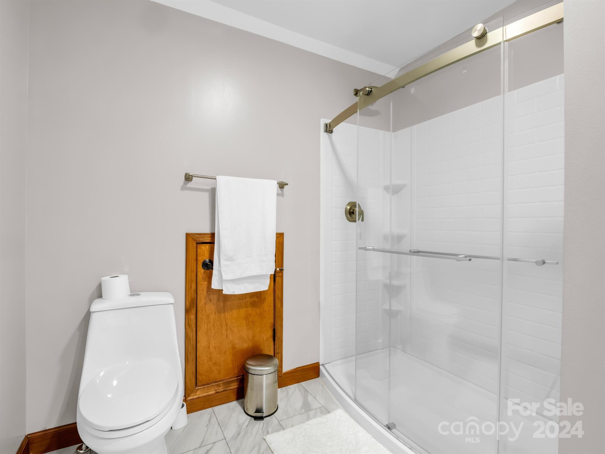 428 Devils Hole Road, Unit 14 Rosman, NC 28772 - Photo 36 of 47 a bathroom with a shower and a toilet
