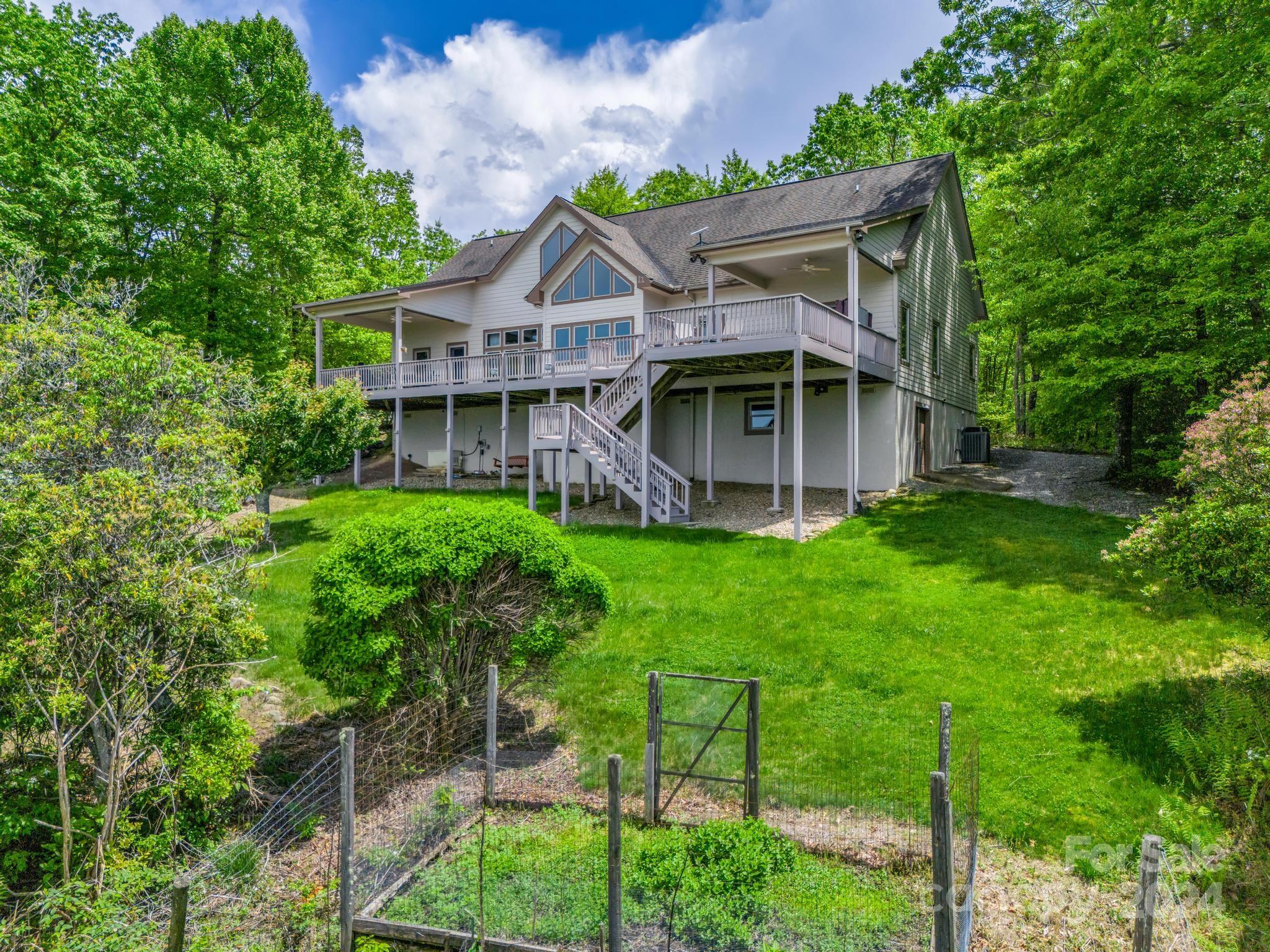 428 Devils Hole Road, Unit 14 Rosman, NC 28772 - Photo 44 of 47 a view of a house with a yard and potted plants