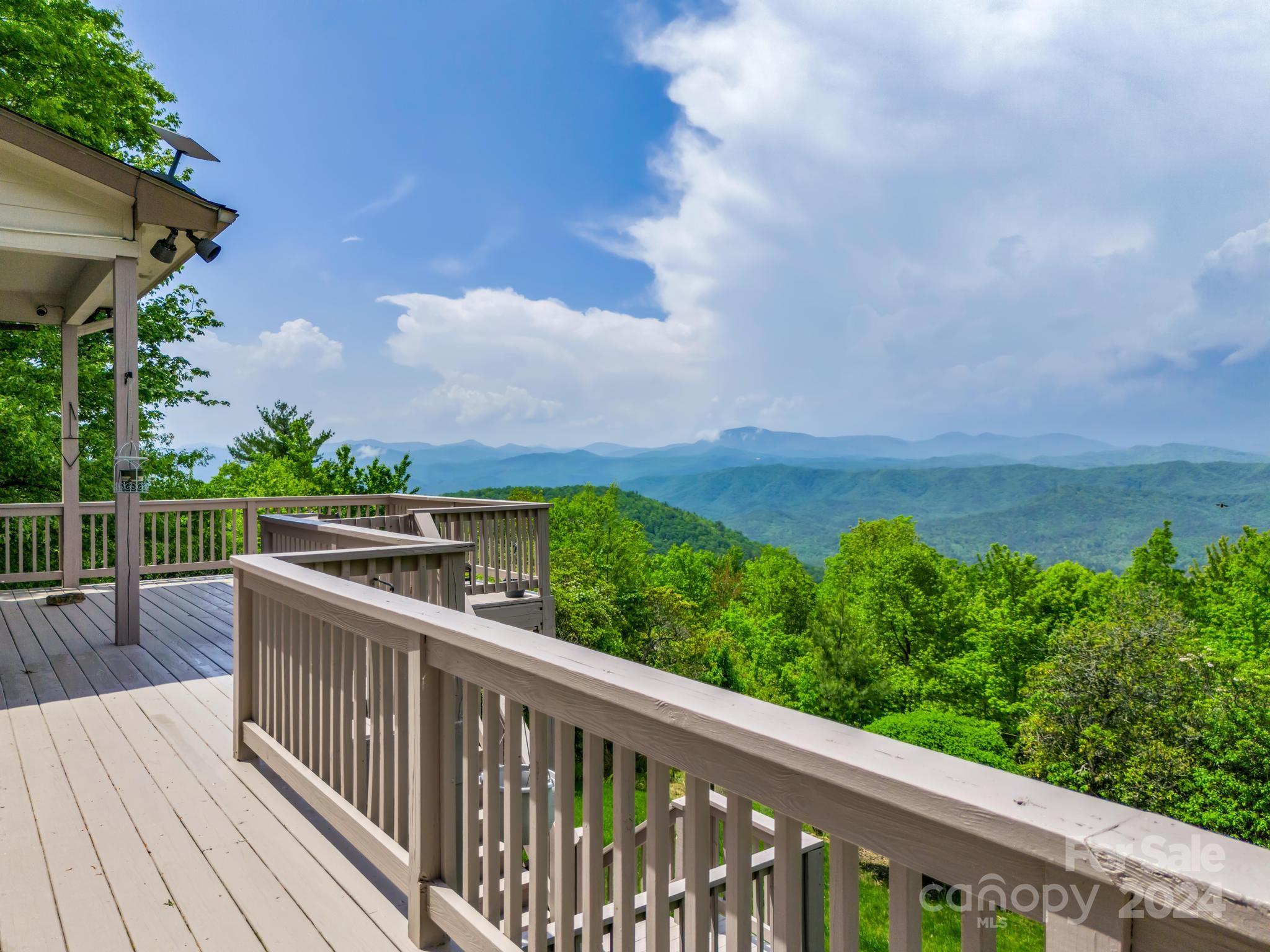428 Devils Hole Road, Unit 14 Rosman, NC 28772 - Photo 6 of 47 a view of a balcony with wooden floor & fence