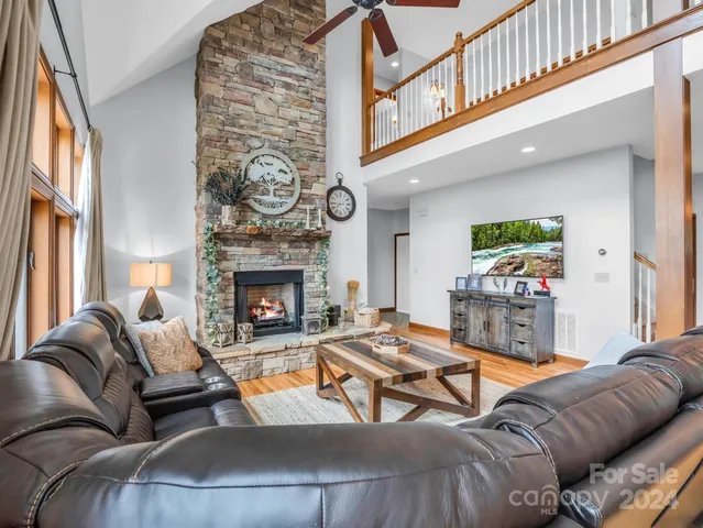 a living room with furniture a table and a large window
