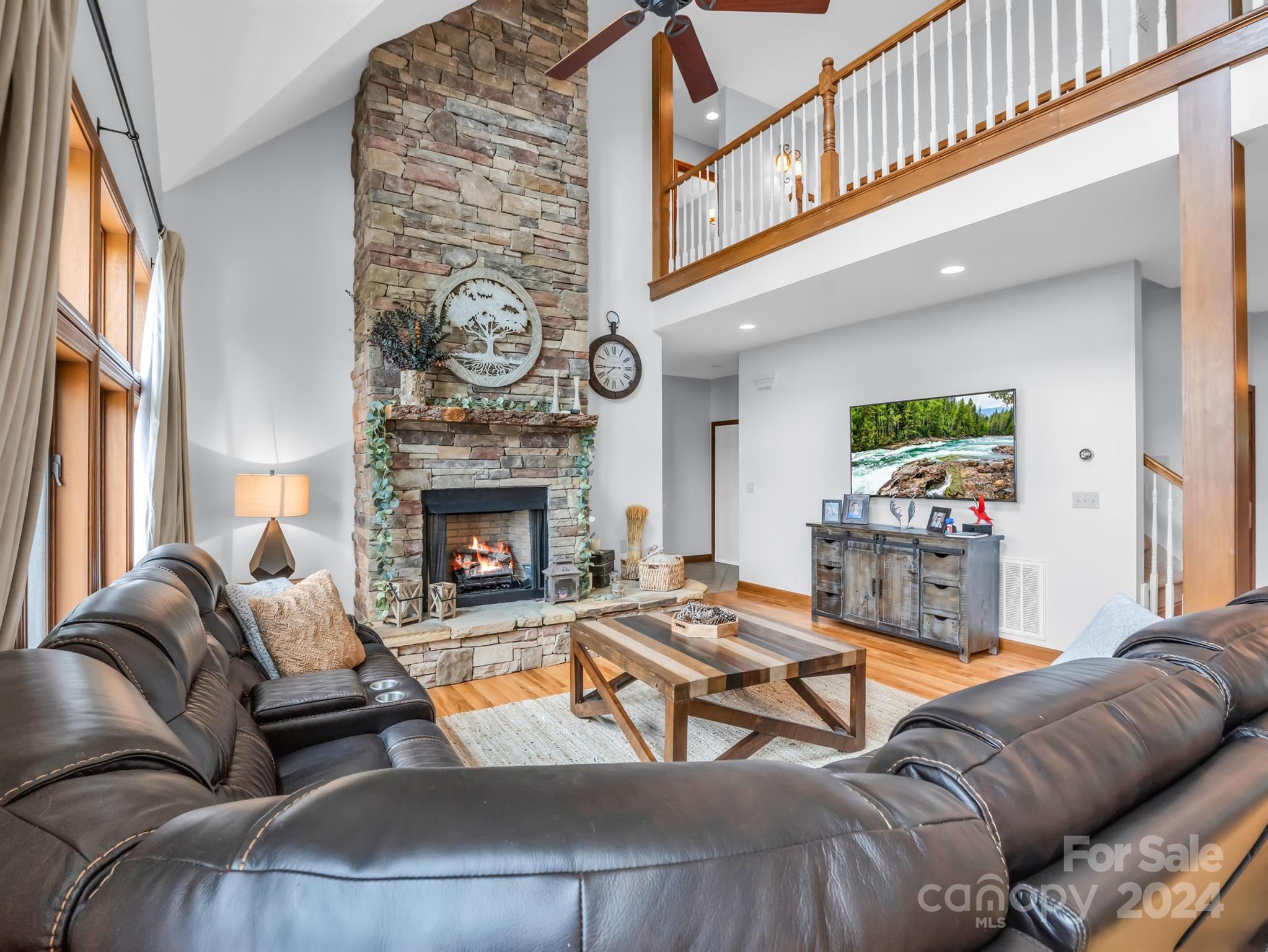 428 Devils Hole Road, Unit 14 Rosman, NC 28772 - Photo 10 of 47 a living room with furniture and a fireplace