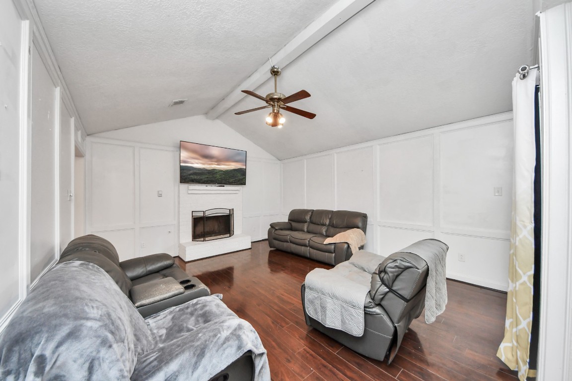 1415 Parry-Sound Pasadena, TX 77504 - Photo 11 of 39 a living room with furniture a fireplace and a flat screen tv