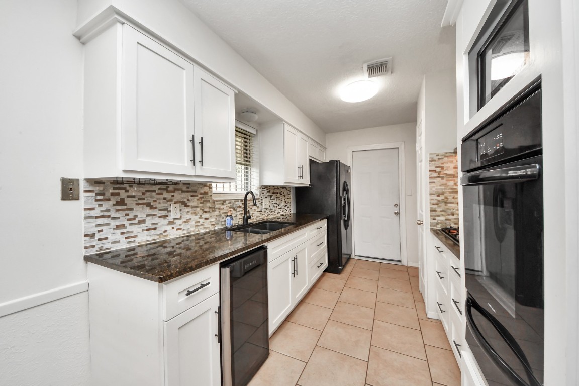 1415 Parry-Sound Pasadena, TX 77504 - Photo 15 of 39 a kitchen with stainless steel appliances granite countertop a sink stove and refrigerator