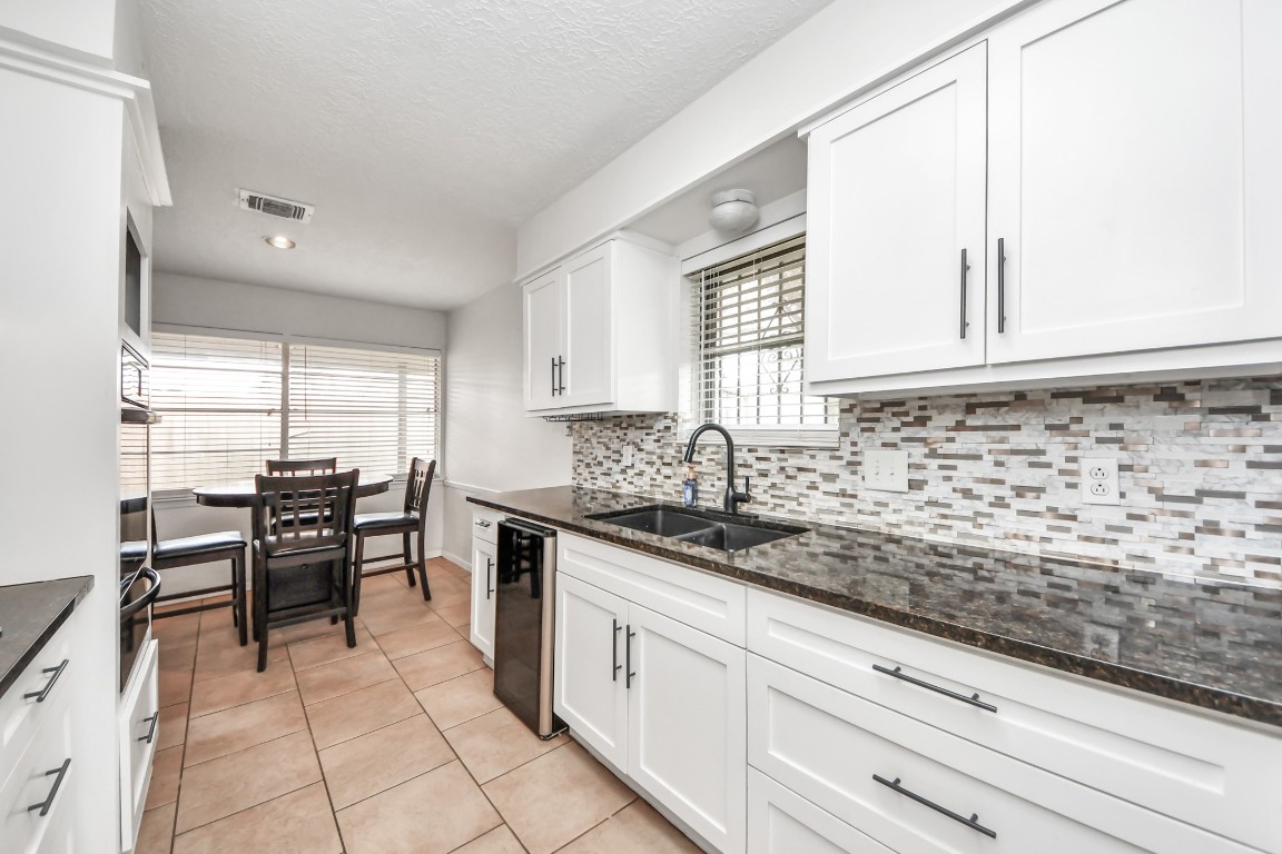1415 Parry-Sound Pasadena, TX 77504 - Photo 19 of 39 a kitchen with granite countertop sink cabinets and window