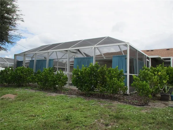 a view of a house with a yard and plants