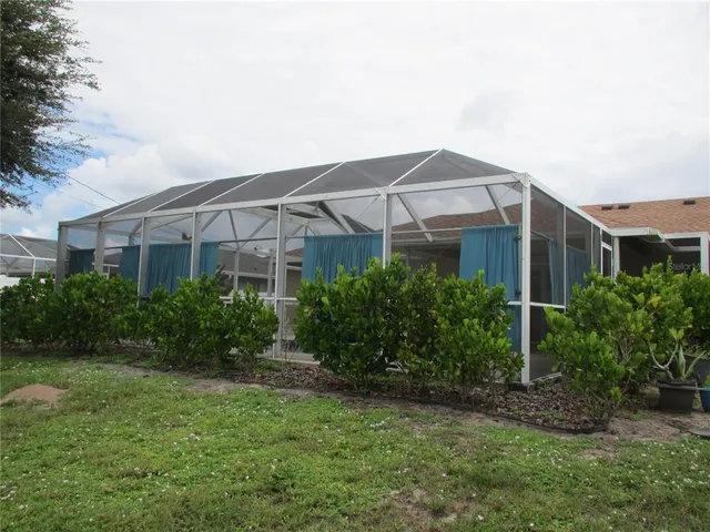 a view of a house with a yard and plants