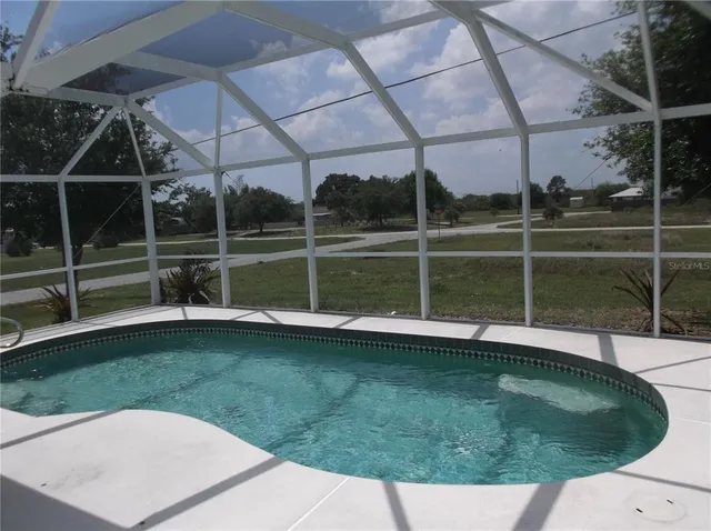 a view of a swimming pool with a yard