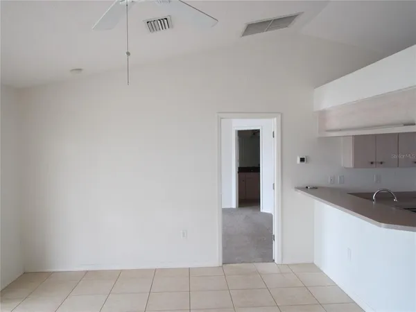 a view of a kitchen with white cabinets