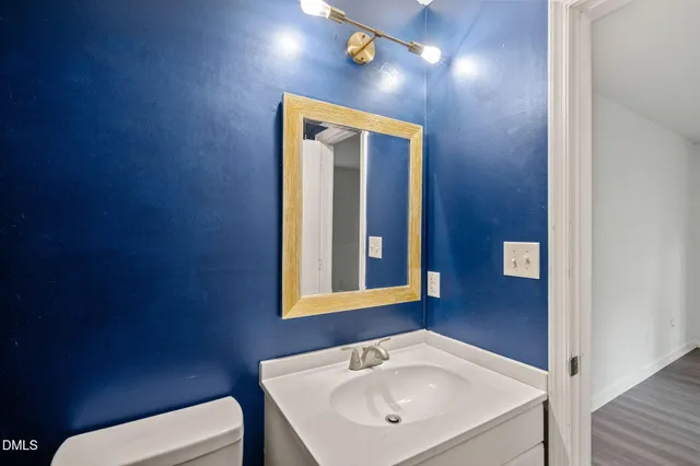 a bathroom with a toilet a sink and mirror