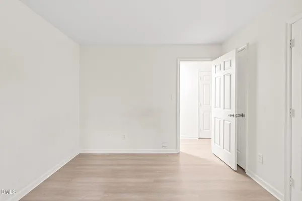 a view of a kitchen with white cabinets