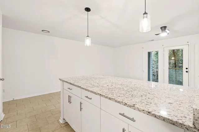 a view of a kitchen with kitchen island sink and refrigerator