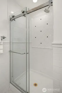 a bathroom with a glass shower door