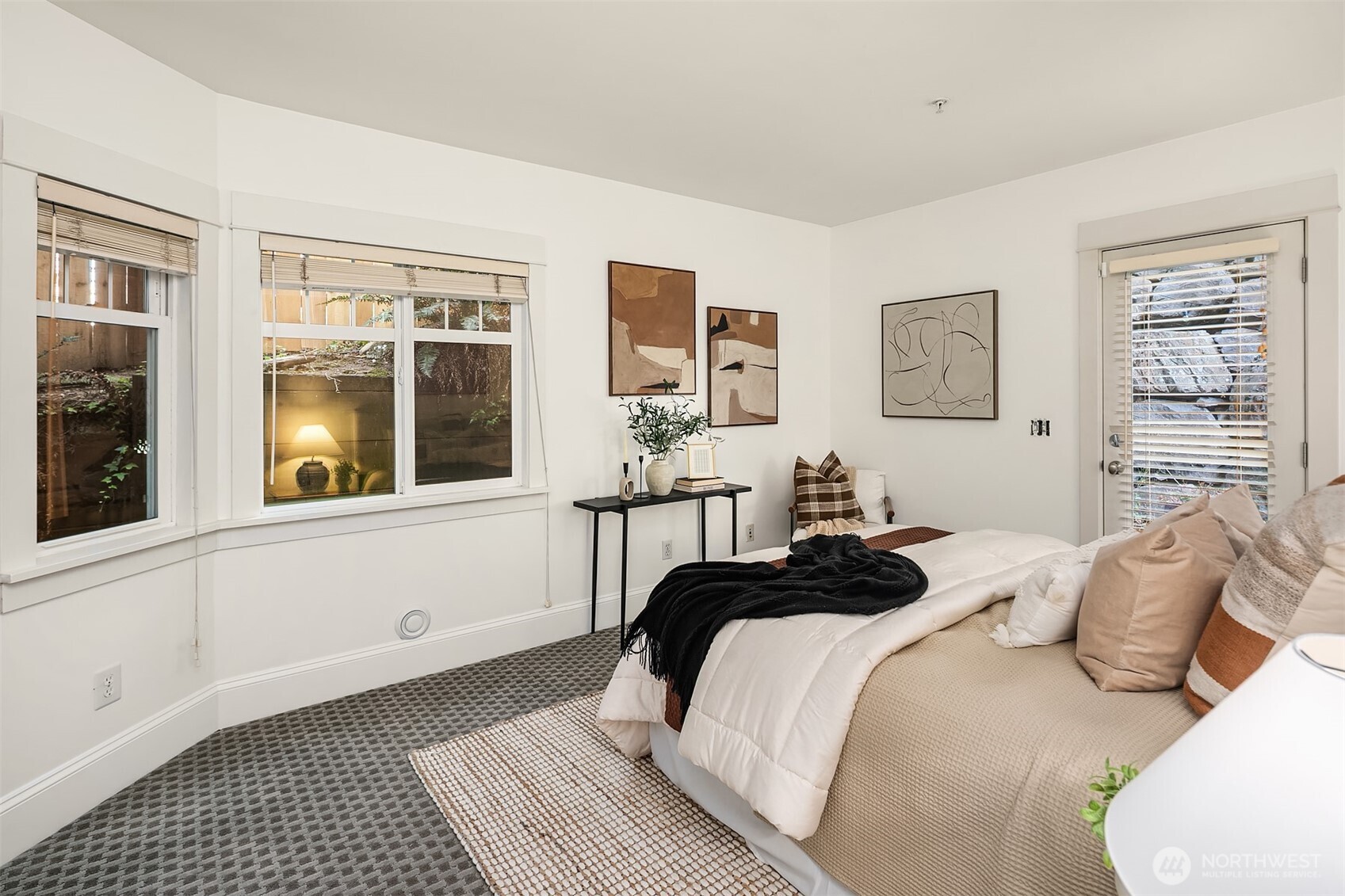 1206 East Republican Street Seattle, WA 98102 - Photo 17 of 27 a bedroom with a bed and glass windows