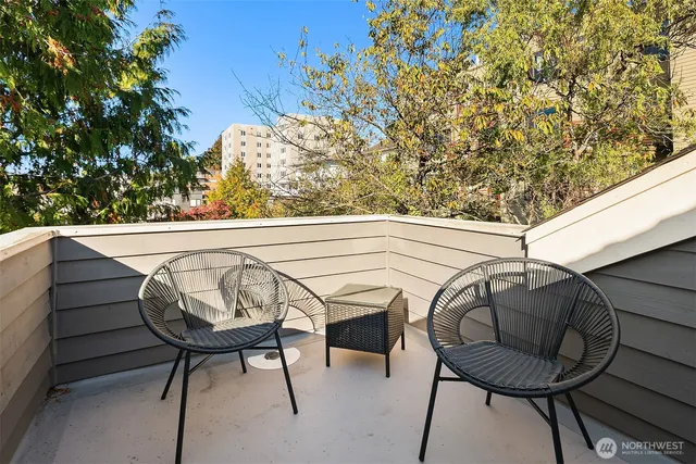 a view of a chairs and table in the balcony