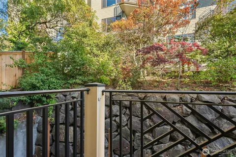 a view of a balcony with wooden floor and fence