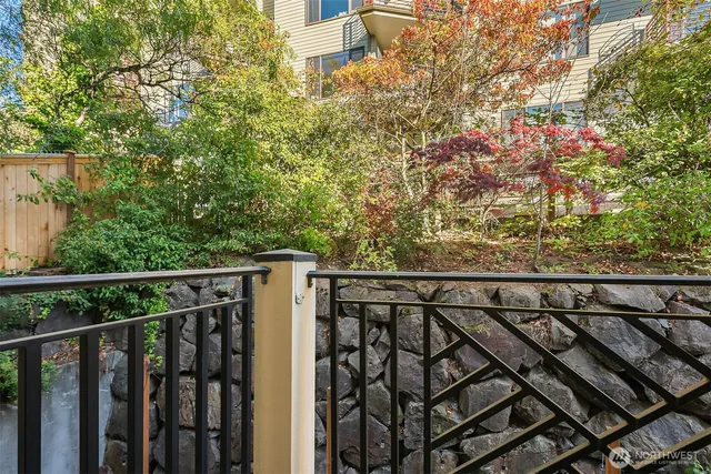 a view of a balcony with wooden floor and fence