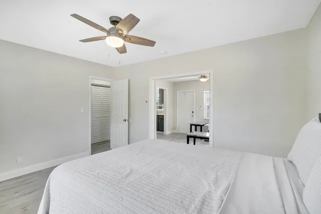 a bedroom with a large bed and a chandelier