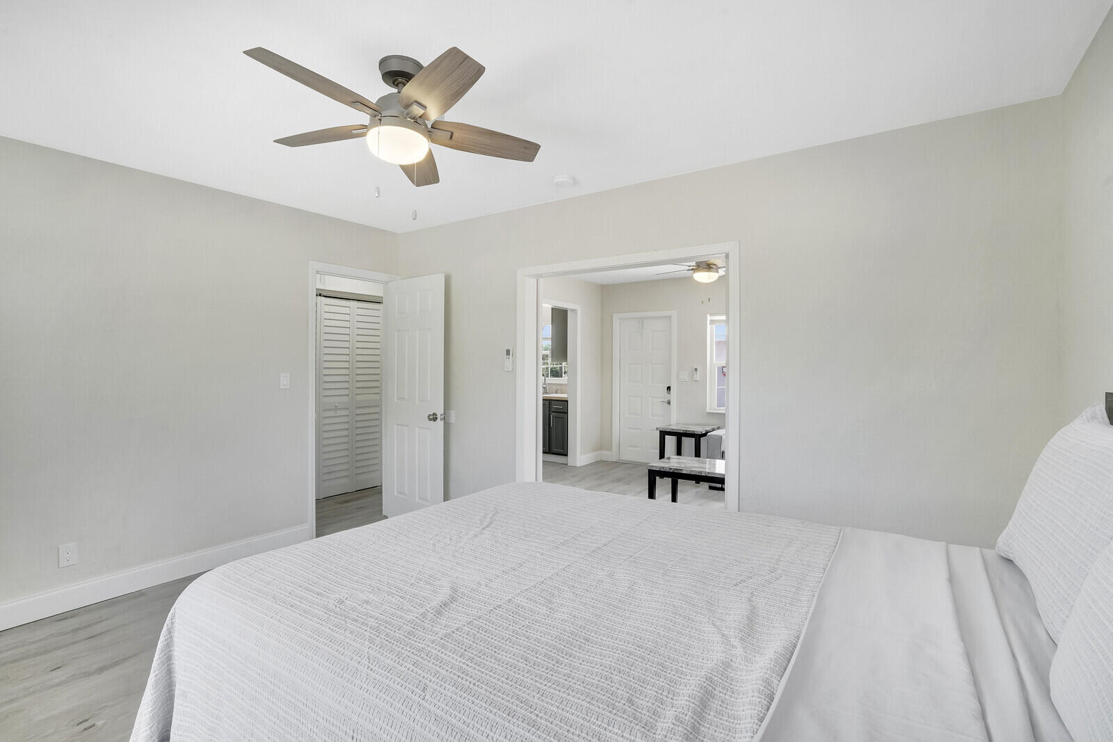 1001 South Federal Highway, Unit 3 Lake Worth Beach, FL 33460 - Photo 11 of 12 a bedroom with a large bed and a chandelier