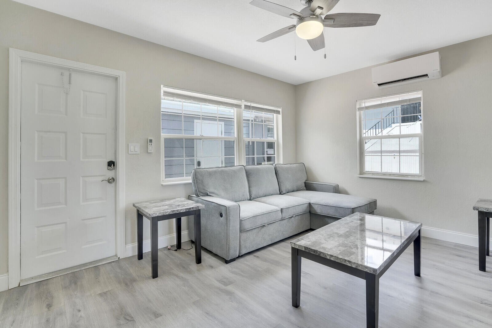 1001 South Federal Highway, Unit 3 Lake Worth Beach, FL 33460 - Photo 2 of 12 a living room with furniture and a window
