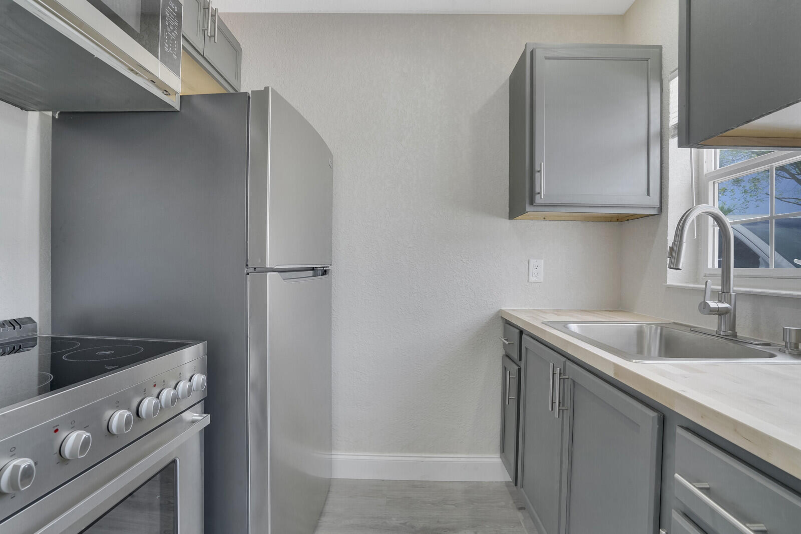 1001 South Federal Highway, Unit 3 Lake Worth Beach, FL 33460 - Photo 6 of 12 a kitchen with a sink and a refrigerator
