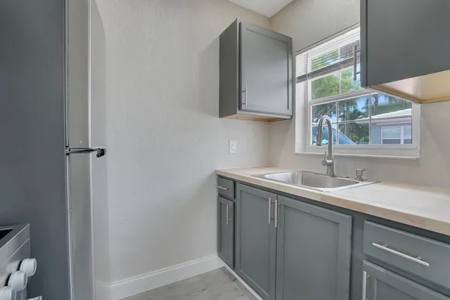 a bathroom with a granite countertop sink a toilet and a mirror