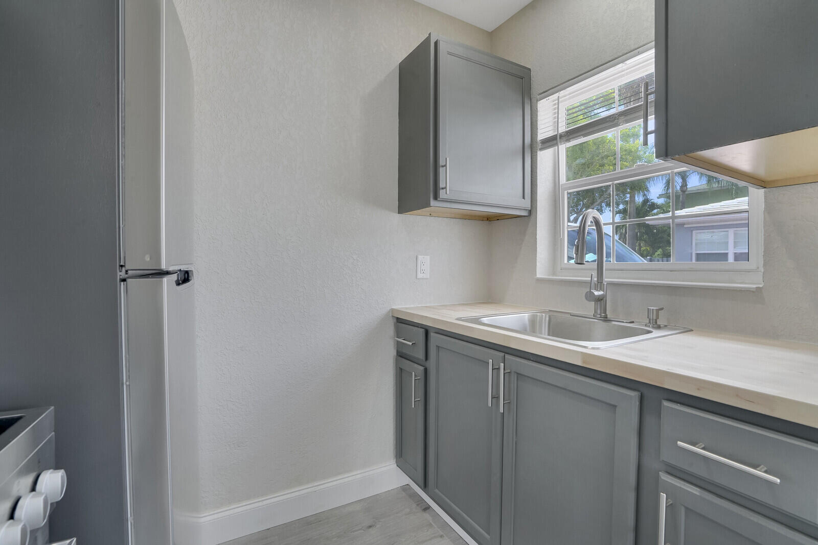 1001 South Federal Highway, Unit 3 Lake Worth Beach, FL 33460 - Photo 7 of 12 a bathroom with a granite countertop sink a toilet and a mirror
