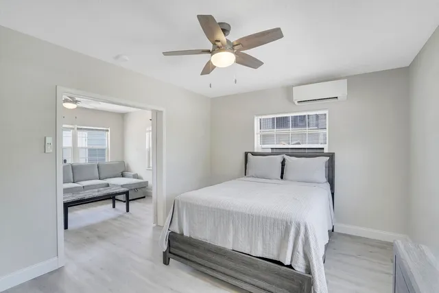 a bedroom with a large bed and a chandelier