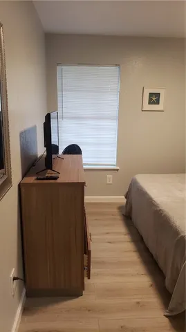 a bedroom with a bed and a television