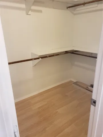 a kitchen with granite countertop a refrigerator a stove a sink and white cabinets