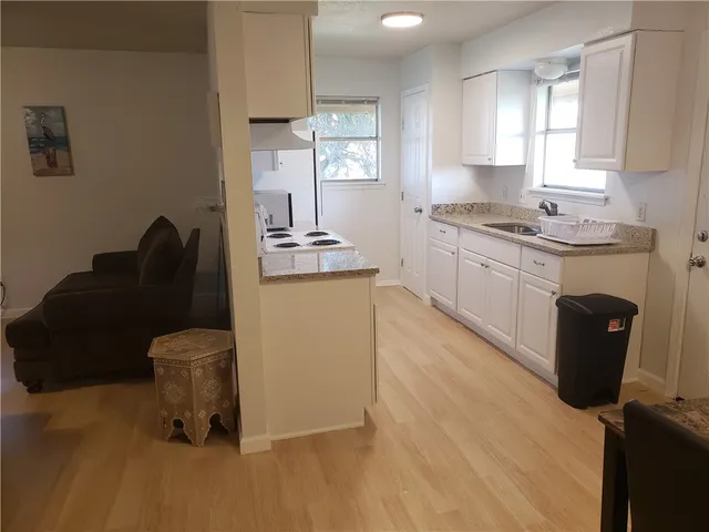 a white toilet sitting next to a window