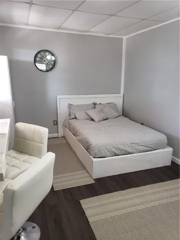 a living room with furniture a flat screen tv and a window