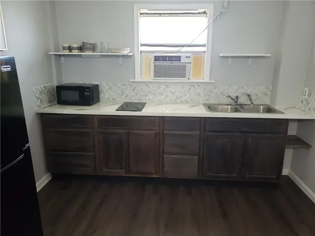 a kitchen with a refrigerator and a sink