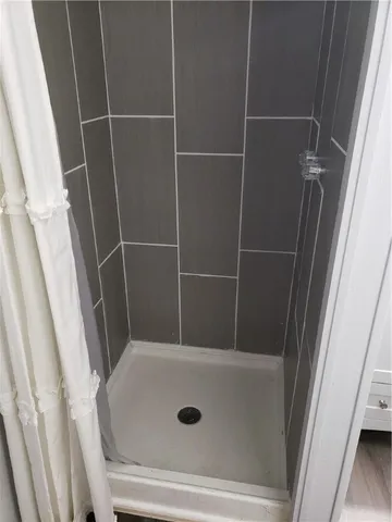 a kitchen with white cabinets and refrigerator