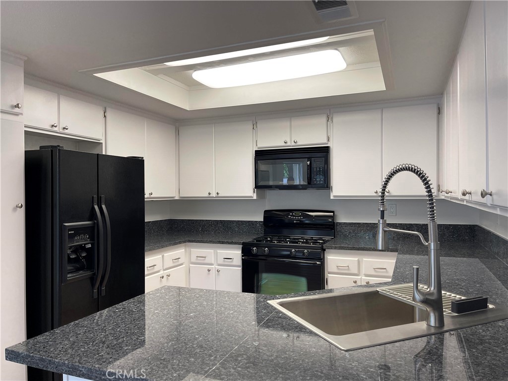 26445 Dunsmore, Unit 2 Lake Forest, CA 92630 - Photo 12 of 36 a kitchen with a refrigerator sink and stove