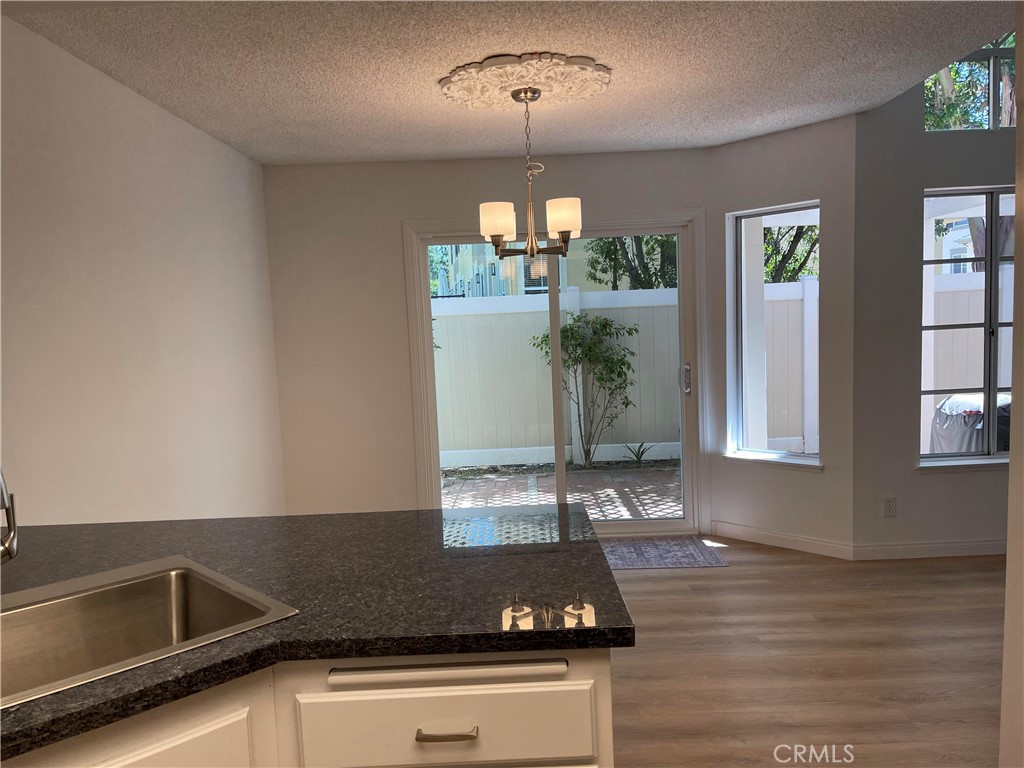 26445 Dunsmore, Unit 2 Lake Forest, CA 92630 - Photo 13 of 36 a view of a kitchen counter space a sink and appliances