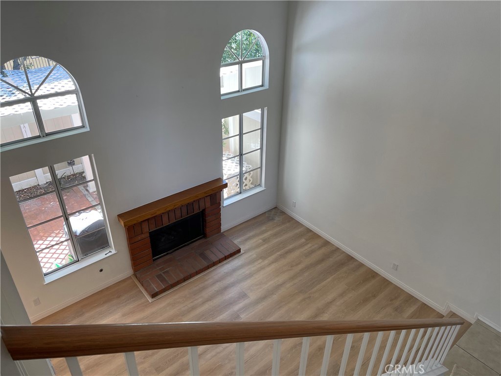 26445 Dunsmore, Unit 2 Lake Forest, CA 92630 - Photo 15 of 36 workspace with wooden floor fireplace and windows